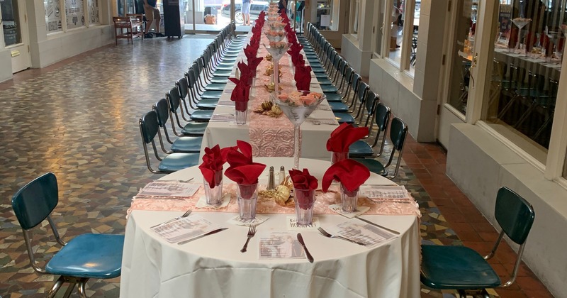 Interior, a tables featuring vibrant red napkins, flowers and organized place settings