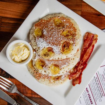 Pancakes with butter and bacon.
