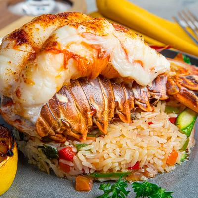 Lobster Tail,  primavera rice, grilled lemon, close up.