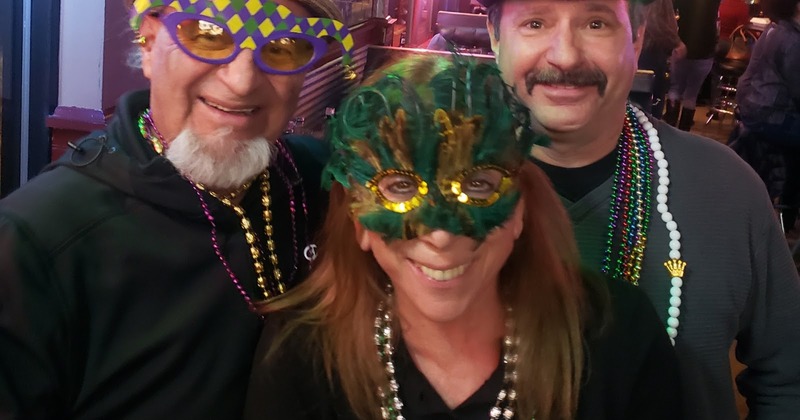 Guests wearing party masks