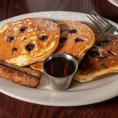 Buttermilk Pancakes, maple syrup and two sausages.