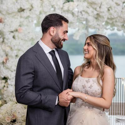 Newlyweds holding hands.