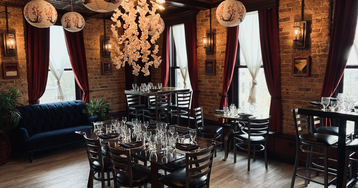 Interior featuring a rustic brick aesthetic and prominent cherry blossom chandeliers
