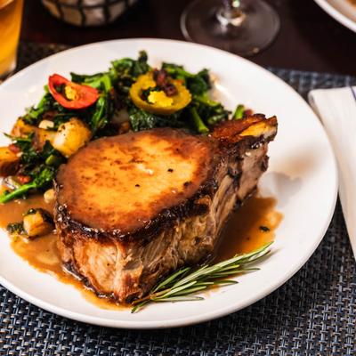 Double Pork Chop served with broccoli rabe, cherry peppers, roasted potatoes.