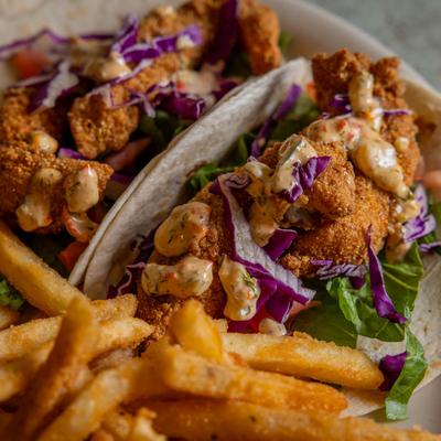 Fried catfish tacos served withfries.