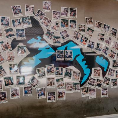 Numerous photographs on the wall.