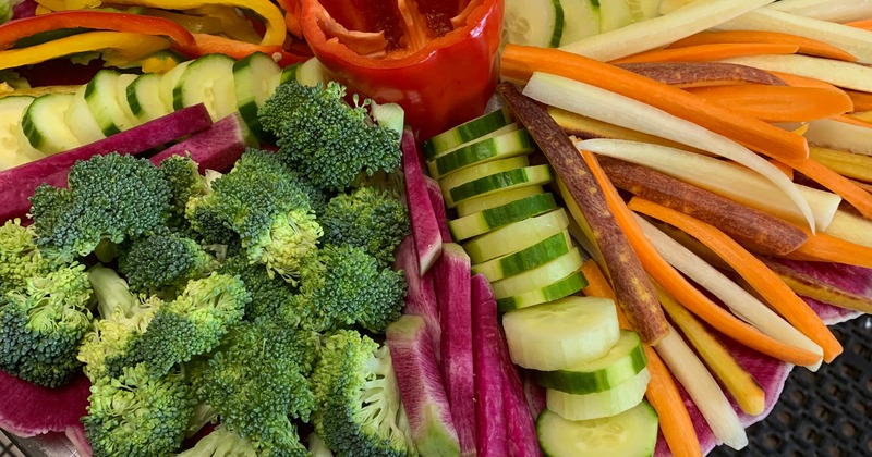 Salad, with carrots, broccoli, cucumber, purple sweet potatoes, and bell peppers