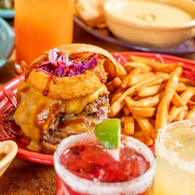 Texas BBQ cheeseburger, with bacon, onion rings, brisket, jalapeno, red cabbage, and fries.