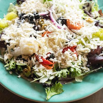 Greek Salad with olives, roasted red peppers, sliced red onions and feta crumbles.