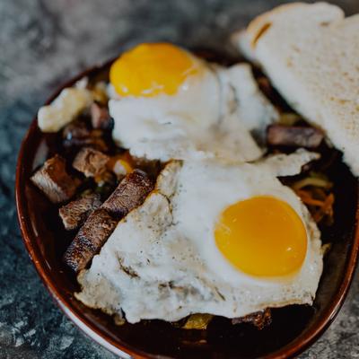 Steak and eggs with a slice of bread.