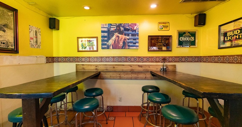 Interior, long wooden top tables with blue leather padded bar stools