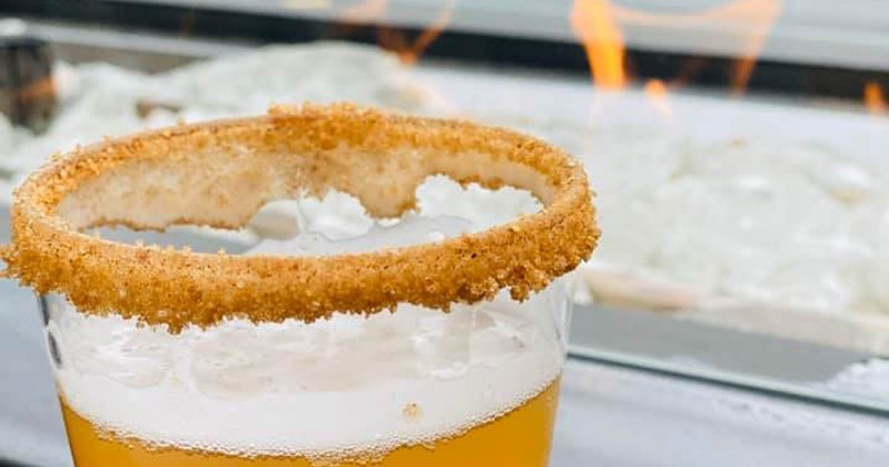A picture of our Pumpkin Chai Wheat beer with our signature rim of cream cheese and cinnamon sugar!