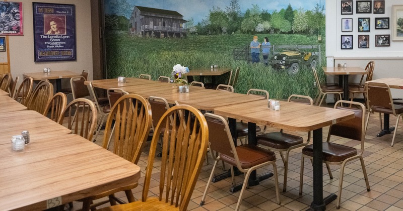 A cozy restaurant interior with wooden tables and chairs