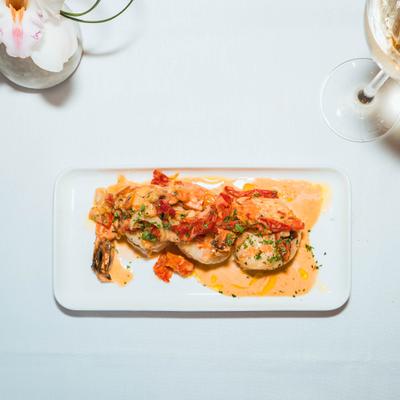 Pan-seared shrimp with garlic, shallots, and sun-dried tomatoes.