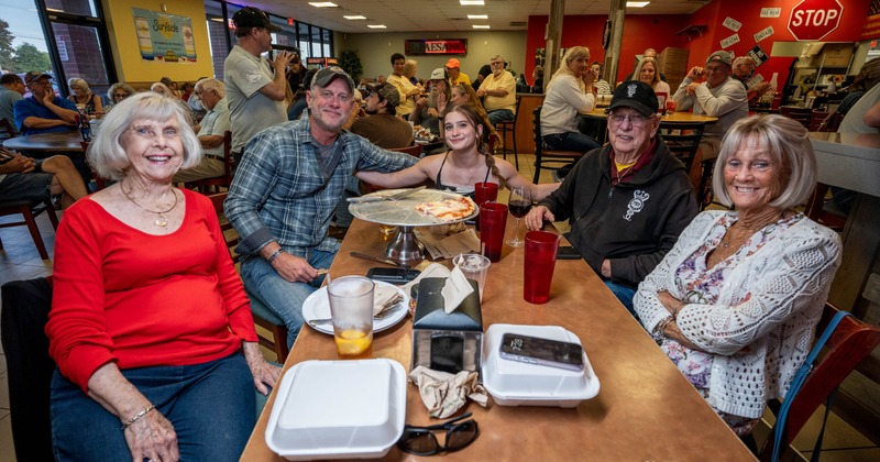 Friends sharing a meal in a busy restaurant