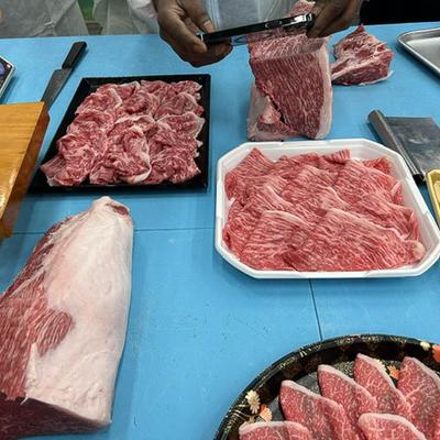 Different types of beef cuts displayed on a blue table.