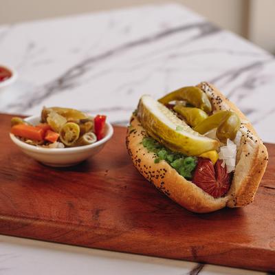 Hot Dog with peppers and pickles.