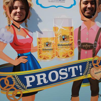 Guests posing in a cardboard cutout.