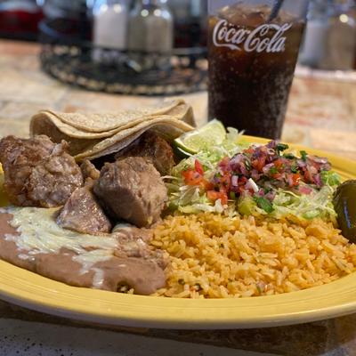 Cooked pork with rice, refried beans, tortillas, and pico de gallo.