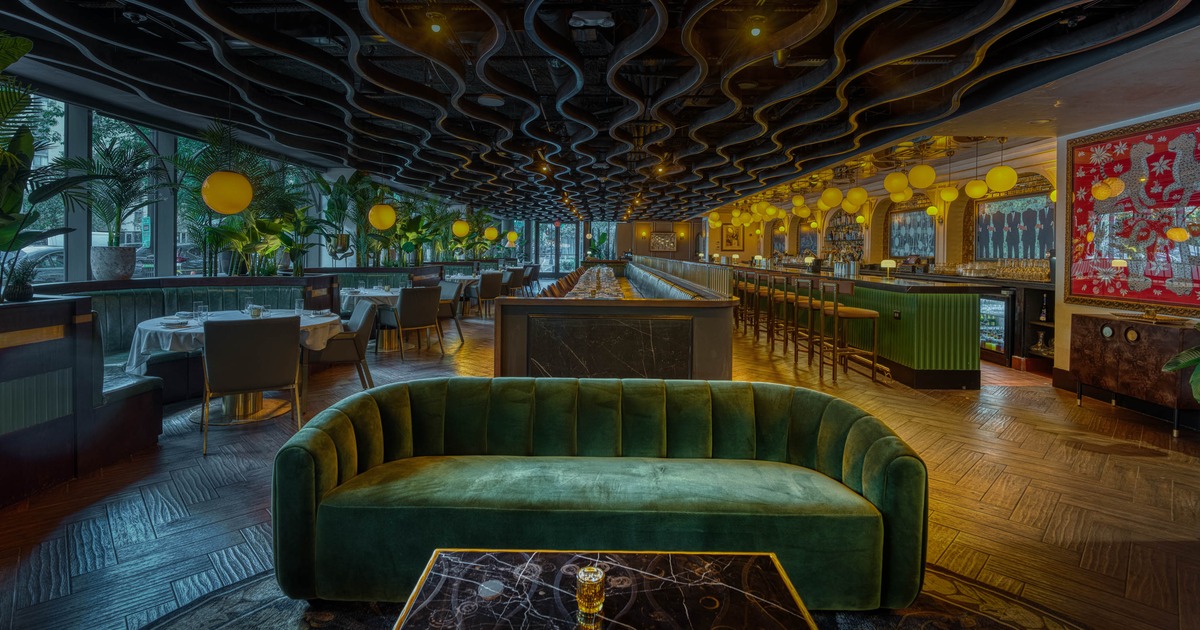 Interior, dining area, sofa with table upfront, dining and bar area in the back
