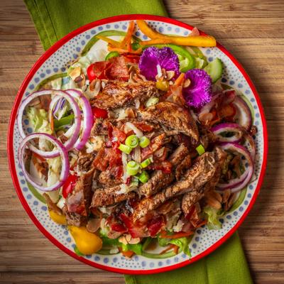 Grilled Caribbean Chicken Salad served on a decorative plate.