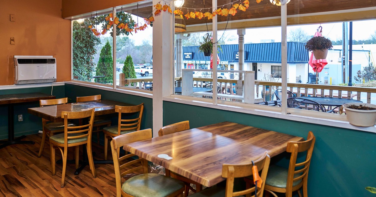 Interior, seating area, tables for four, large window area, patio view