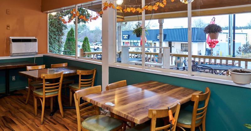 Interior, seating area, tables for four, large window area, patio view