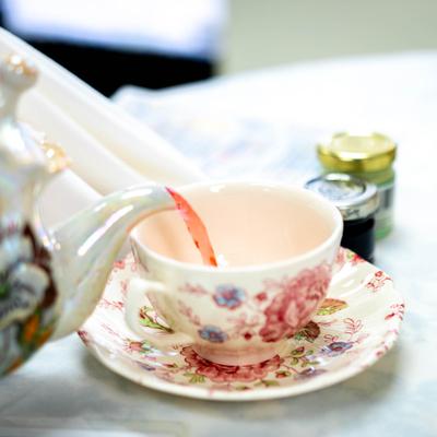 Tea being poured in a cup.