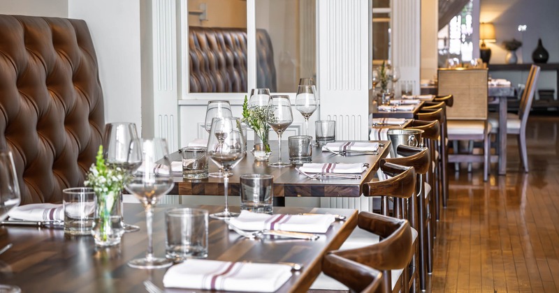 Interior, tables all lined up with glasses and tableware