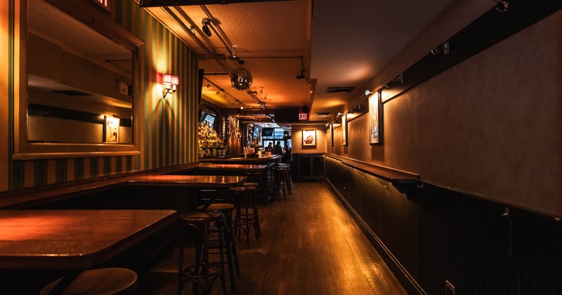 Interior, high tables and chairs with bar in the back