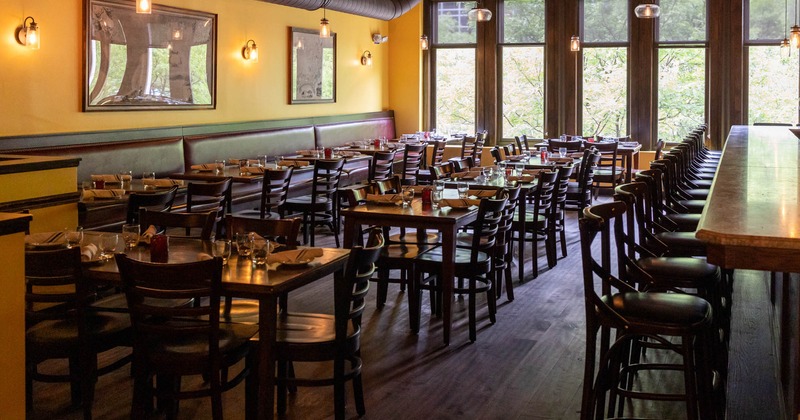 Interior, long banquette seating, dining tables, tableware