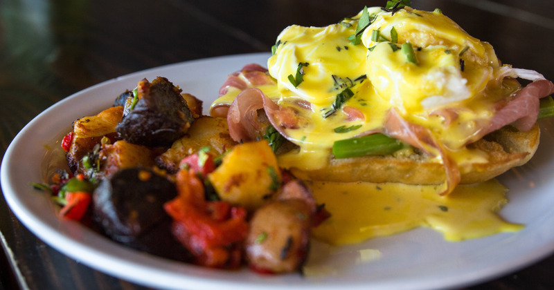 Eggs with ham and bread and potatoes on the side closeup