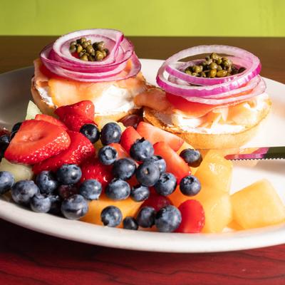 Bagel lox served with fresh fruits.