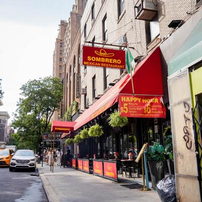 Restaurant exterior, patio, hanging potted plants.