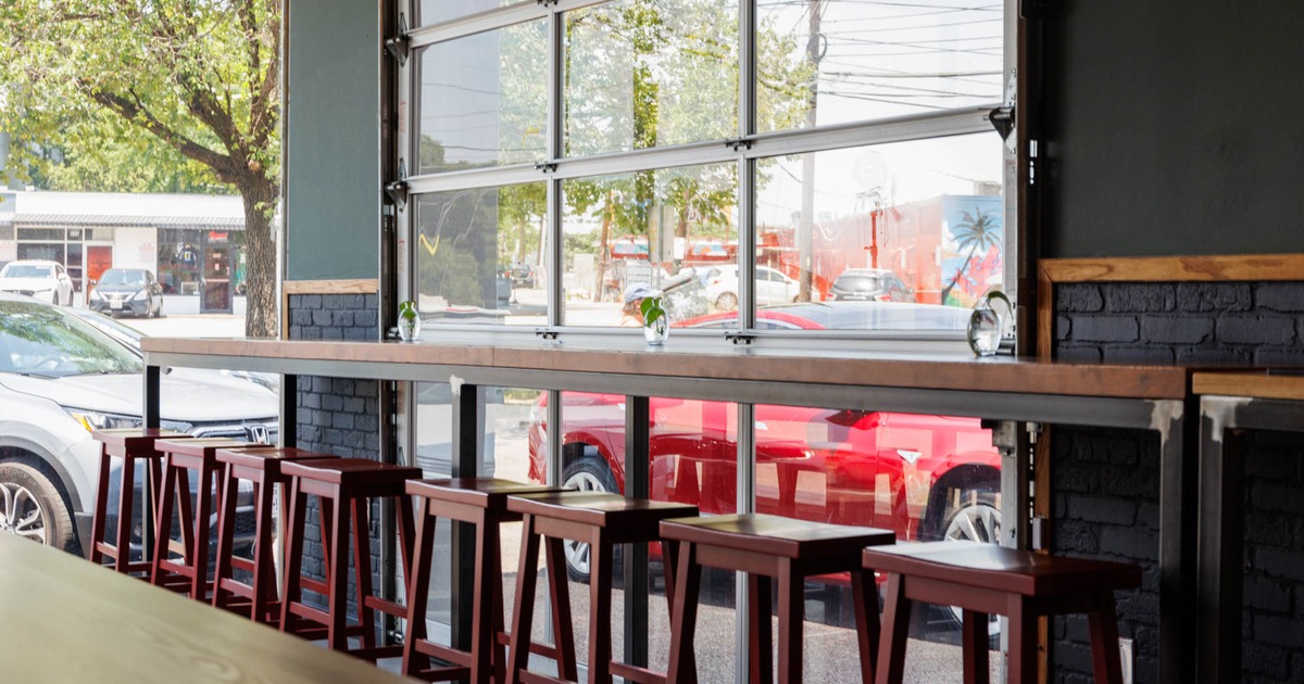 Interior, long, high table and chairs lined up