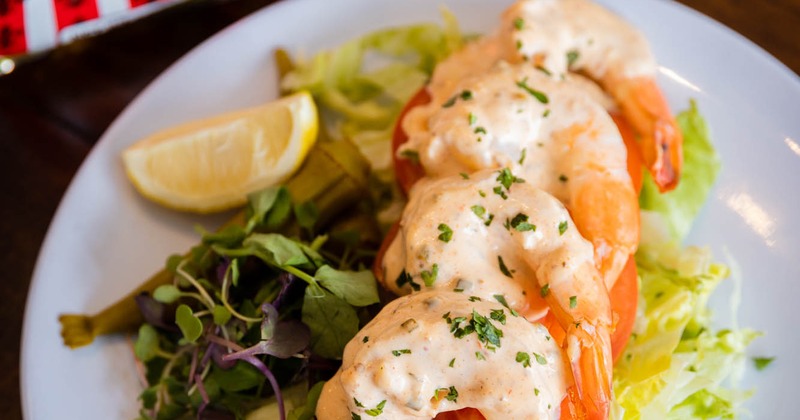 Seasoned shrimp with shredded lettuce, tomatoes, and remoulade sauce