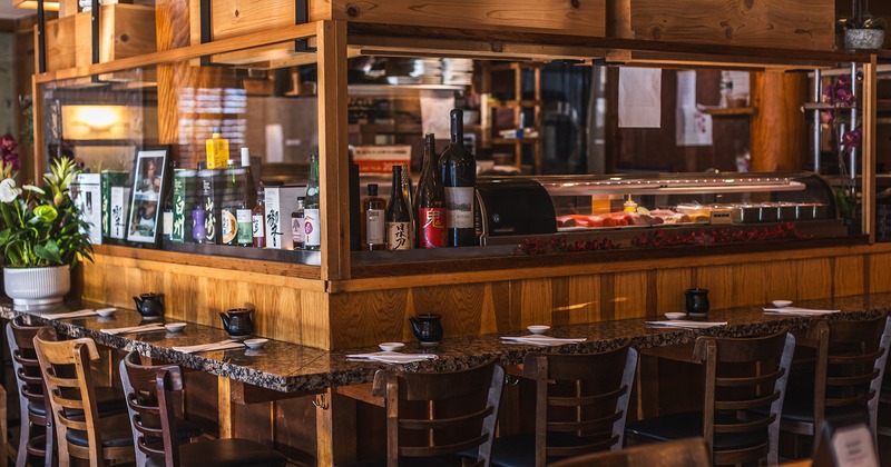 A horseshoe-shaped sushi bar sits at the restaurant's center