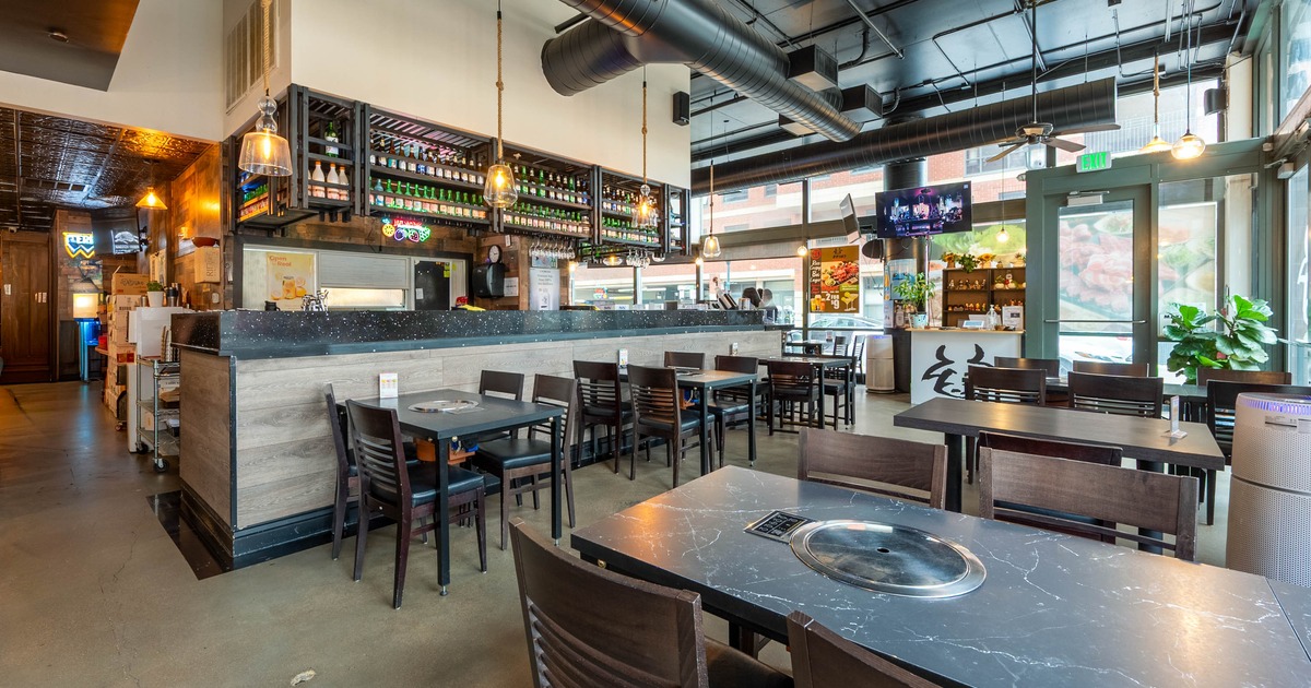 Interior, dining area, Korean grill tables for four people, bar, restaurant entrance