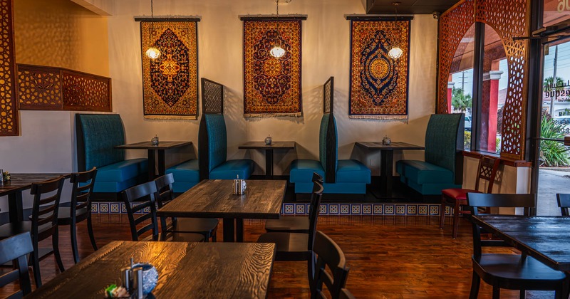 Interior, seating booths with tables, regular tables for four, Arabian motif decoration