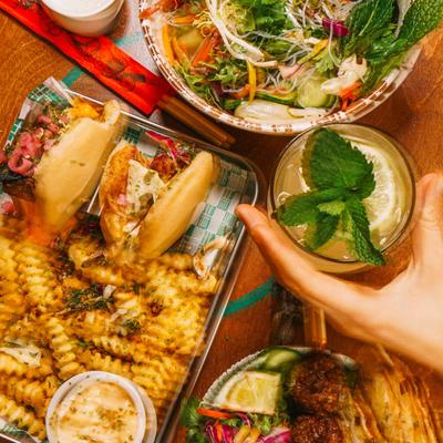 A blurry overhead view of  dishes and drinks.