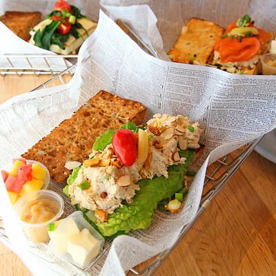 Sandwich with white topping, green salad and mixed salad on top