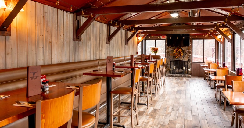 Interior, dining area, high banquette bench with high tables and stools, regular tables for two