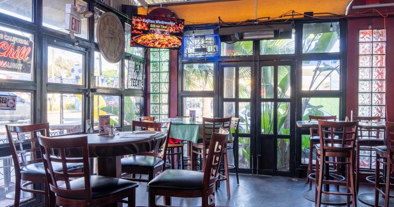 Interior, seating area, high and regular tables with chairs,
