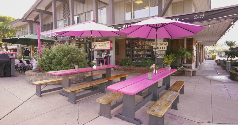 Outdoor seating area, long picnic tables with parasols