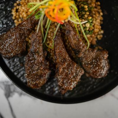 Seared lamb chops with  maafé peanut sauce and herbed couscous.
