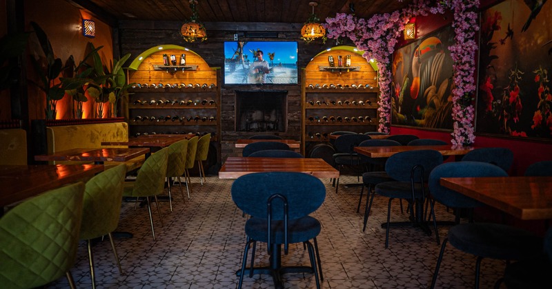 Interior seating area with chairs, booths and tables, dim lighting