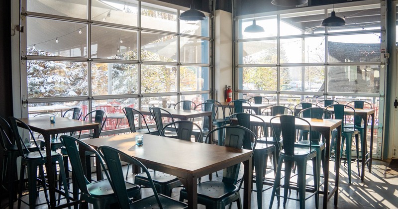 Interior, shop windows, high tables with stools, chandeliers