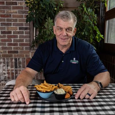 The restaurant owner sitting.