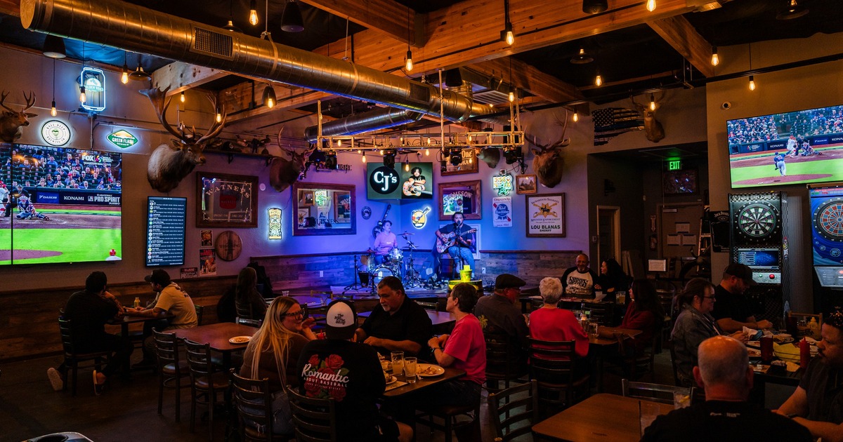 Interior, seating area with stage for live concerts, tv screens and darts