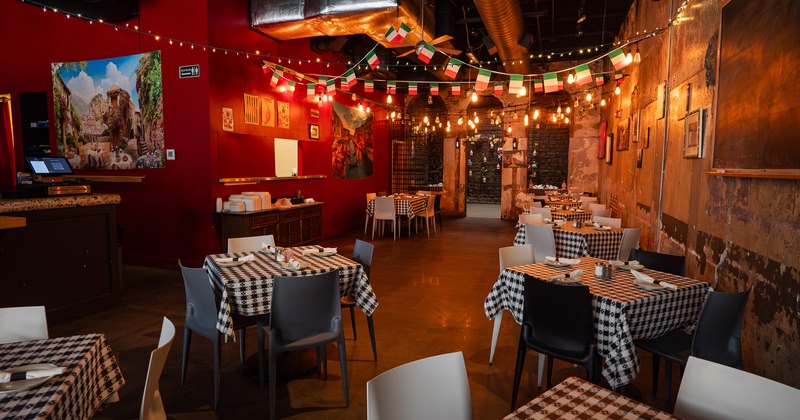 Nicely done and cozy Italian-style restaurant interior dining area with set tables